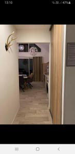 a hallway leading to a kitchen and a living room at La Cooconing in Fresnicourt-le-Dolmen