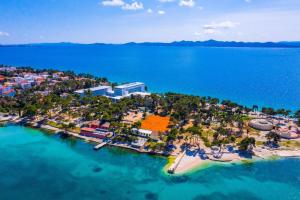 an aerial view of a small island in the water at Hotel Pinija in Petrcane