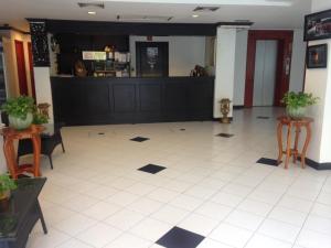 a lobby with a restaurant with a counter and chairs at Lotus House in Jomtien Beach