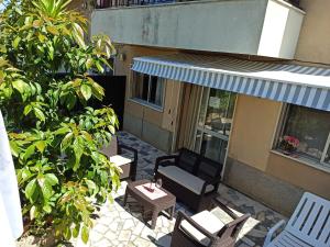 a patio with chairs and a table and a building at Apartamento Solvita in Coimbra
