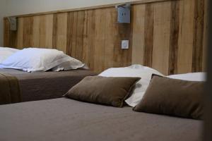 two beds with pillows in a hotel room at L'Arche de Porquerolles in Porquerolles