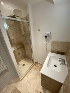 a bathroom with a sink and a shower at L'Arche de Porquerolles in Porquerolles