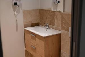 a bathroom with a sink and a mirror at L'Arche de Porquerolles in Porquerolles