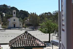 a view of a building with a church in the background at L'Arche de Porquerolles in Porquerolles