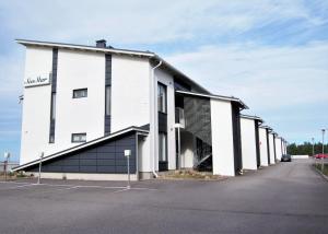 a white building with a sign on the side of it at Seastar 101 in Kalajoki +3 photos