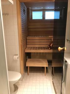 a small bathroom with a bench and a toilet at Seastar 101 in Kalajoki