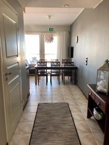 a dining room with a table and chairs and a door at Seastar 101 in Kalajoki