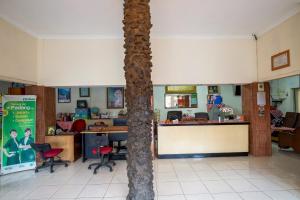 a palm tree in the middle of a room at Hotel Jogja Bukittinggi in Bukittinggi