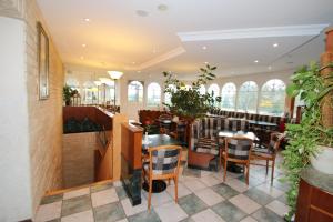 a restaurant with tables and chairs and windows at Hotel -Winterfelder Hof in Winterfeld