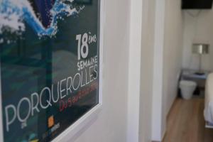 a poster hanging on a wall in a room at L'Arche de Porquerolles in Porquerolles