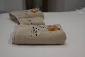 three folded towels sitting on a white table at L'Arche de Porquerolles in Porquerolles