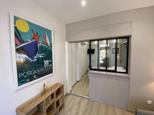 a living room with a bench and a painting on the wall at L'Arche de Porquerolles in Porquerolles