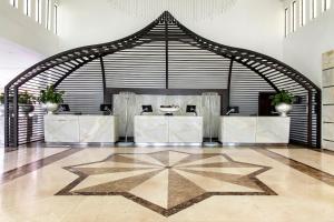 a lobby with a reception desk in a building at Gran Melia Palacio de Isora Resort & Spa in Alcalá