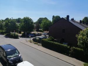a black car parked on a street next to a house at Studio 2 pers. tourisme et business in Namur