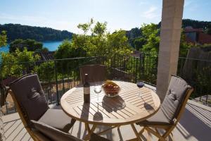 a wooden table and two chairs on a patio at Sweet Old Stone House Cavtat in Cavtat