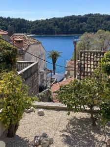 a house with a view of a body of water at Sweet Old Stone House Cavtat in Cavtat