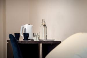 a table with a bottle and glasses on it at Comfort Zone Naples in Naples