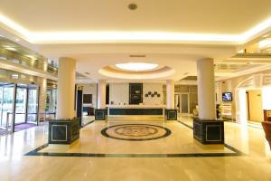 a lobby of a building with a rug on the floor at Ankara Vilayetler Evi in Golbası