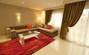 a living room with a couch and a table at AlAshrafia Smart Residence in Cairo