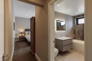 een badkamer met een toilet, een wastafel en een bad bij Howe Top in Bowness-on-Windermere