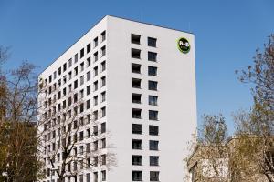 a white building with a logo on the side at B&B HOTEL Basel in Basel