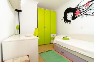 a bedroom with green and white cabinets and a bed at Apartment Giovani in Slano