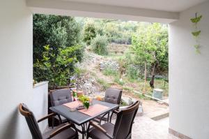 a table and chairs on a patio with a view at Apartment Giovani in Slano