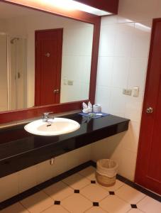 a bathroom with a sink and a mirror at Lotus House in Jomtien Beach +1 photo