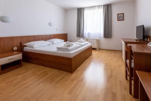 Postel nebo postele na pokoji v ubytování Hotel Porto