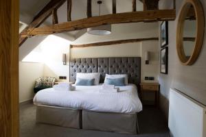 a bedroom with a large bed and a large window at Royal Ship in Dolgellau