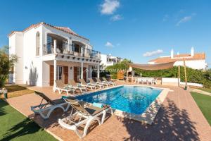 a villa with a swimming pool and a house at Villa BELLAVISTA in Arenal d'en Castell