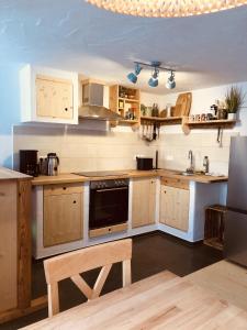 a kitchen with wooden cabinets and a stove top oven at Ferien an der Traun in Traunwalchen