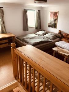 a living room with two beds and a staircase at Ferien an der Traun in Traunwalchen