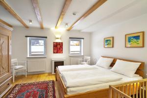 a bedroom with a bed and two windows at Arber Lofts in Bayerisch Eisenstein in Bayerisch Eisenstein +145 photos