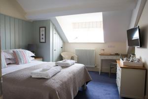 a bedroom with a bed with towels on it at Seacroft in Holyhead