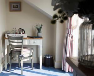 a desk and a chair in a room with a window at Seacroft in Holyhead