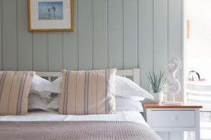 a bedroom with a bed and a picture on the wall at Seacroft in Holyhead