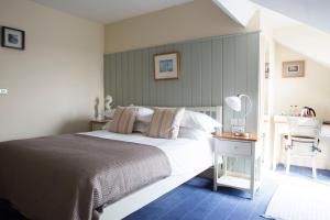 a bedroom with a bed and a desk with a mirror at Seacroft in Holyhead