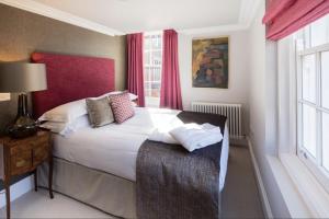 a bedroom with a large bed and a window at Beech House - Urban Apartments in Bristol