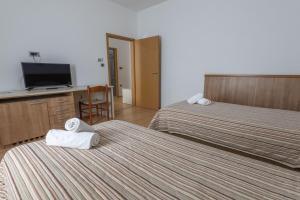 Postel nebo postele na pokoji v ubytování Hotel Porto