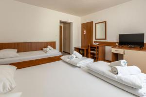 Postel nebo postele na pokoji v ubytování Hotel Porto