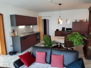 a living room with a couch and a kitchen at Ferienhaus An der Mosel in Zell an der Mosel