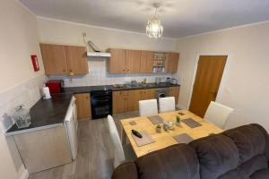a kitchen with a table and a couch in a room at Login house B in Derry Londonderry