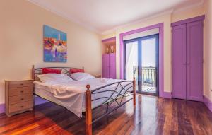 a bedroom with a bed with purple cabinets and a balcony at Exclusive VILLA Volme in Banjole +12 photos