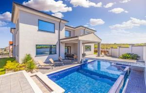 a villa with a swimming pool and a house at Exclusive VILLA Volme in Banjole