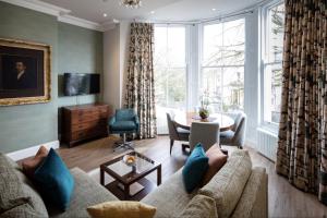 a living room with a couch and a table at Beech House in Bristol