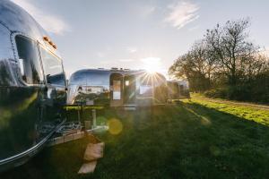 a group of rvs parked in the grass at Silver Airstream Glamping & Rental in Chichester