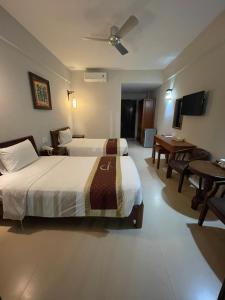 Postel nebo postele na pokoji v ubytování Sunshine Hoian Hotel