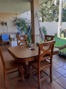 a wooden table and chairs in a living room at La casa deMarta in Córdoba