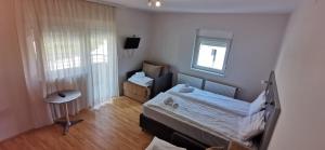 a small bedroom with a bed and a window at Villa MILSA Half Board & Pool in Soko Banja